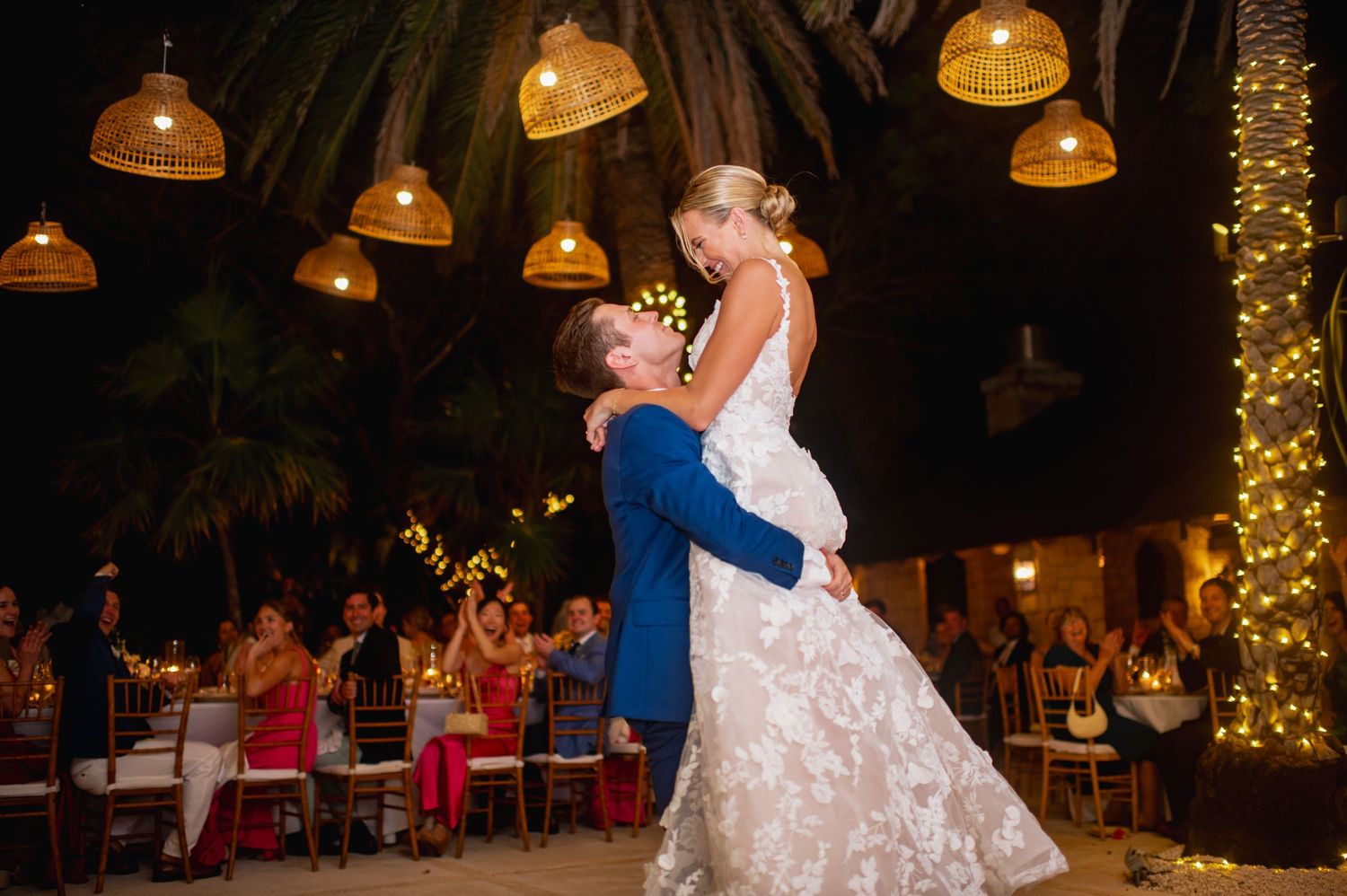 Wedding reception dance floor with hanging lanterns and twinkle lights creating ambient atmosphere.