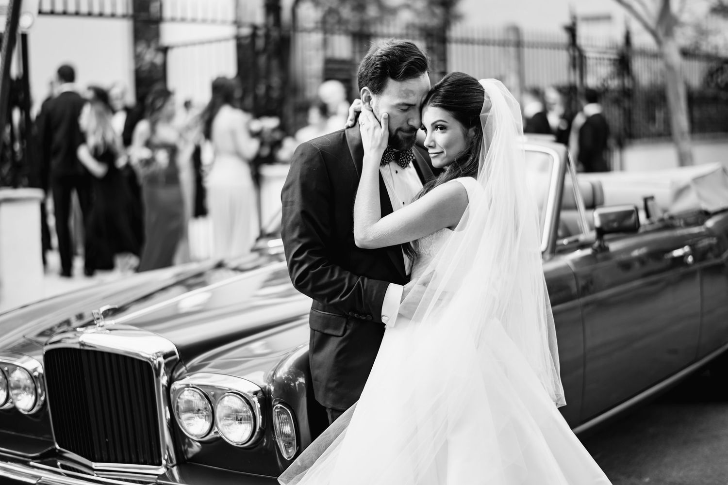 A romantic black and white wedding photo collage showing intimate moments between newlyweds with vintage cars.