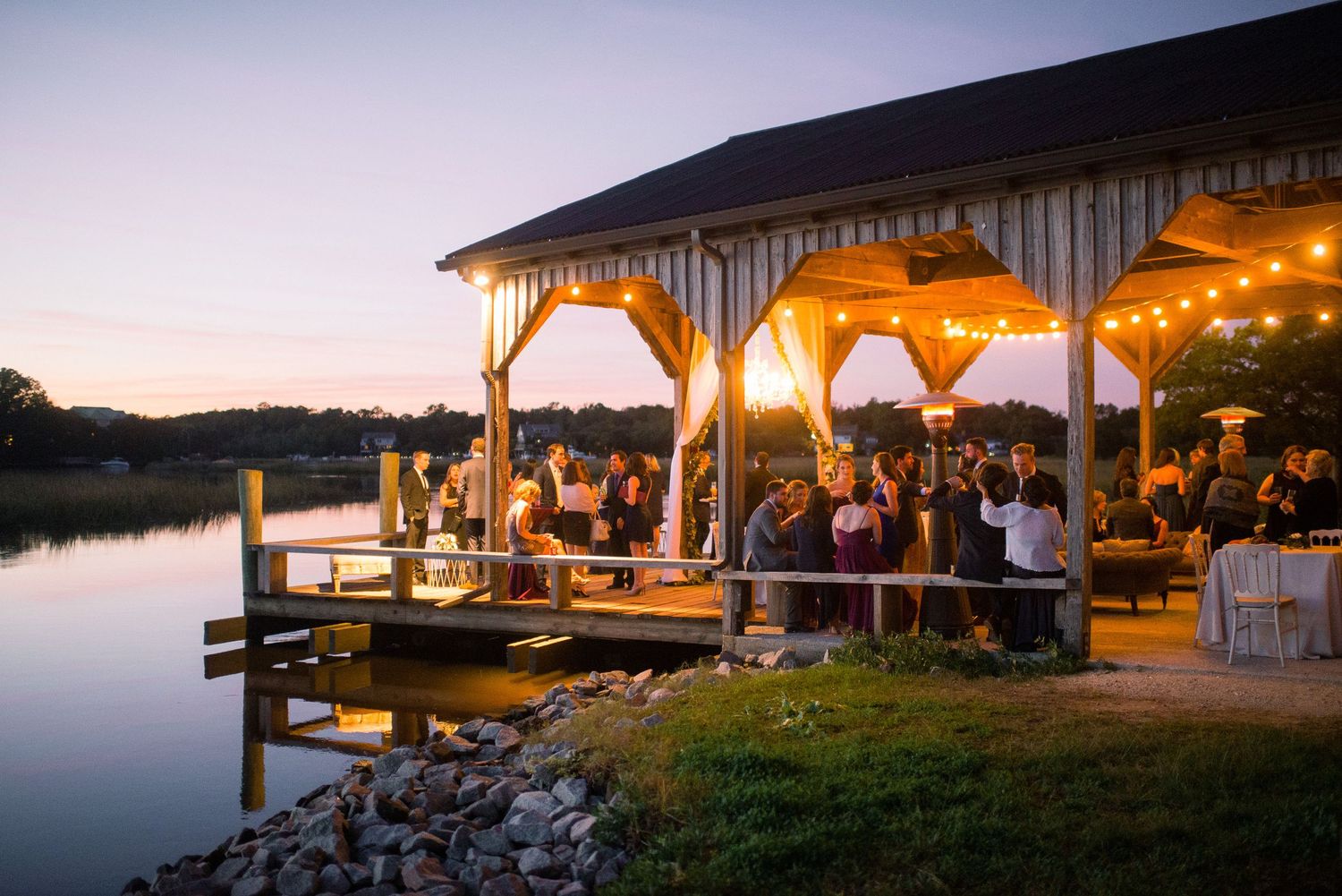 A collection of sunset waterfront images showing docks, pavilions, and outdoor gathering spaces lit with warm glowing lights.
