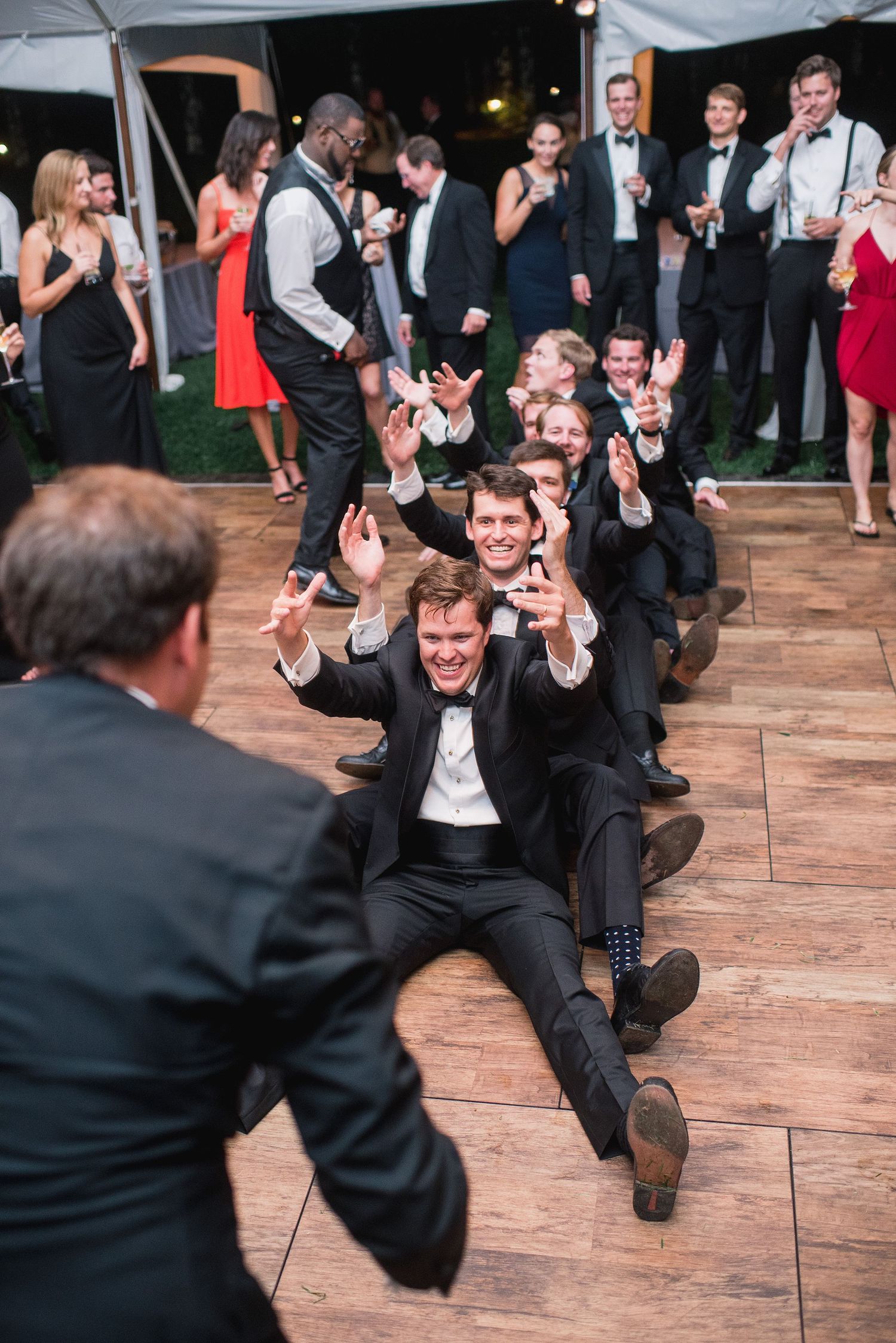 Sequence of wedding reception photos showing groomsmen performing synchronized dance moves on a wooden dance floor.