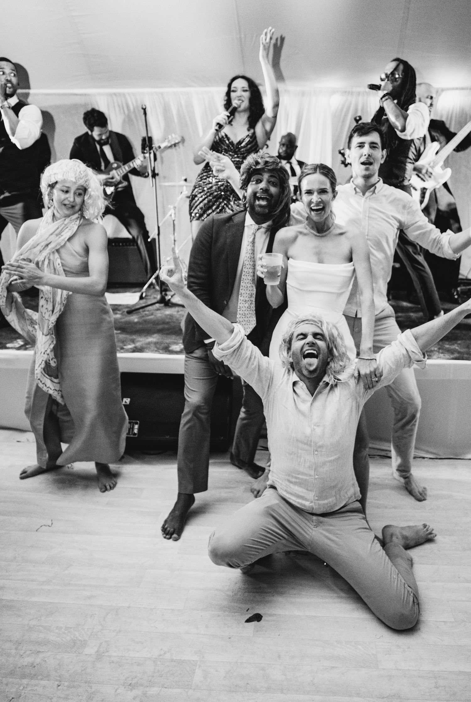 Black and white photo of energetic wedding reception dancing and celebration.