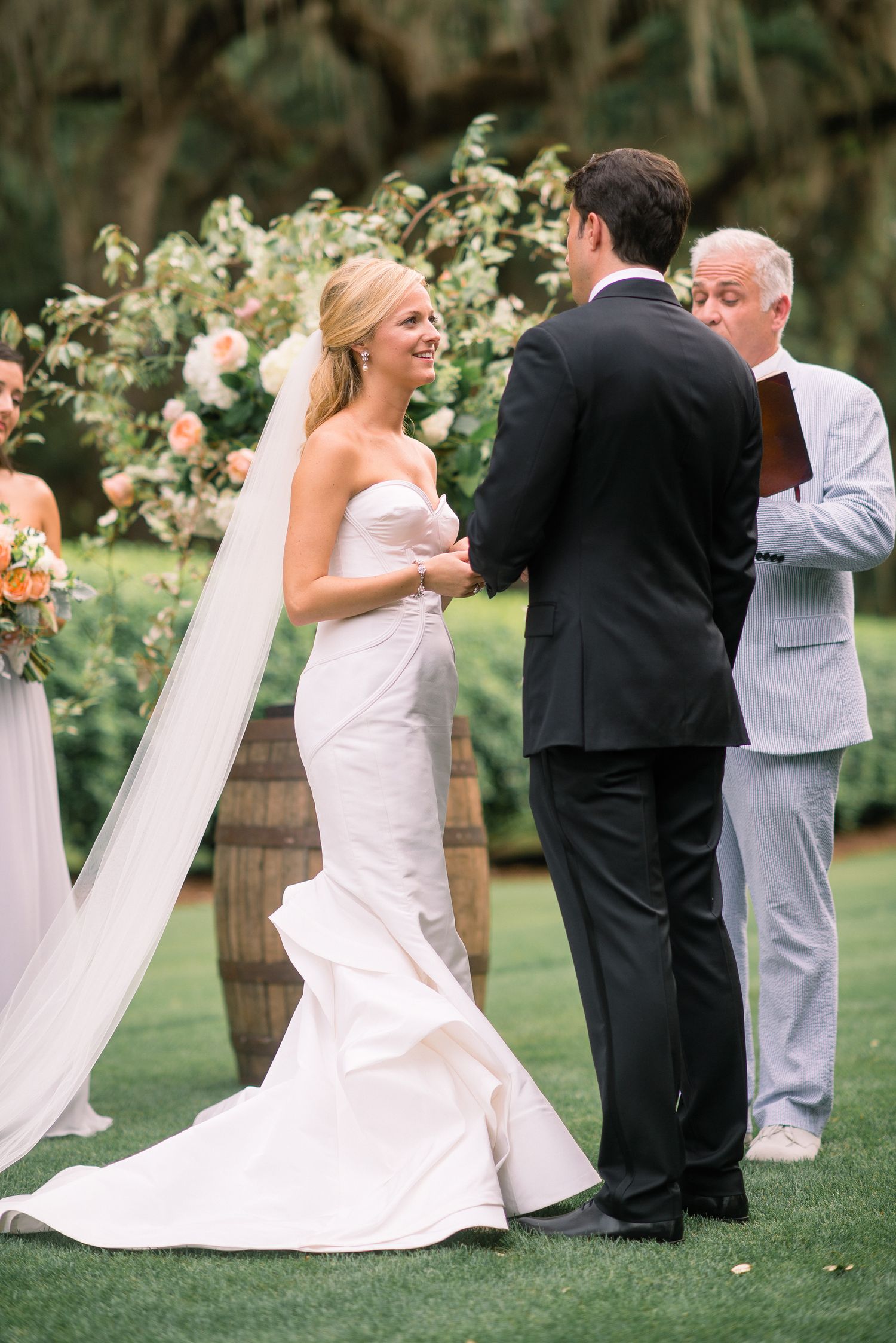 A sequence of playful wedding photos showing the couple and wedding party dancing and celebrating on a grassy lawn.