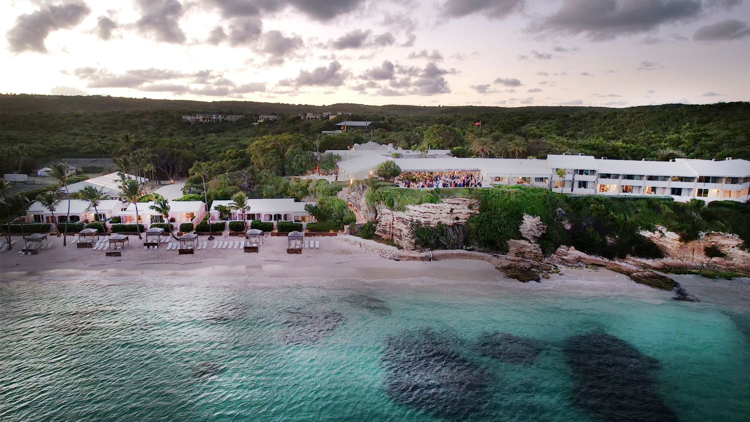 Aerial view of a coastal resort area with pristine beaches and turquoise waters.