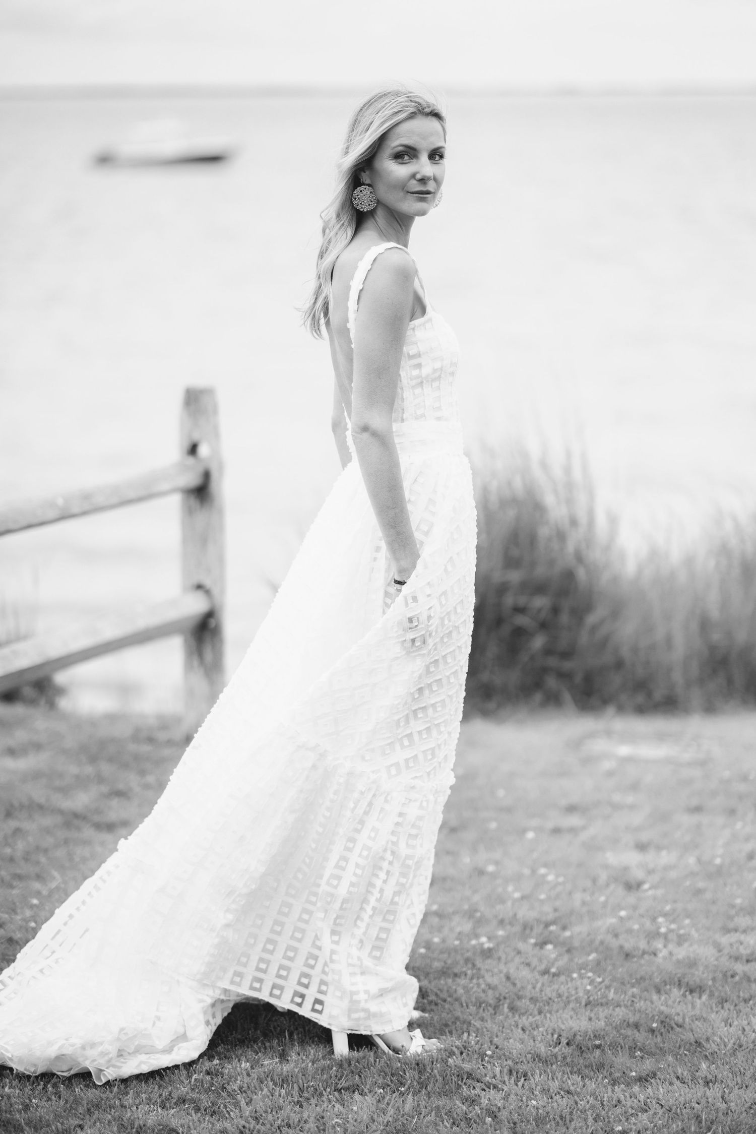 Ethereal black and white photo series of a flowing white dress twirling in a meadow.
