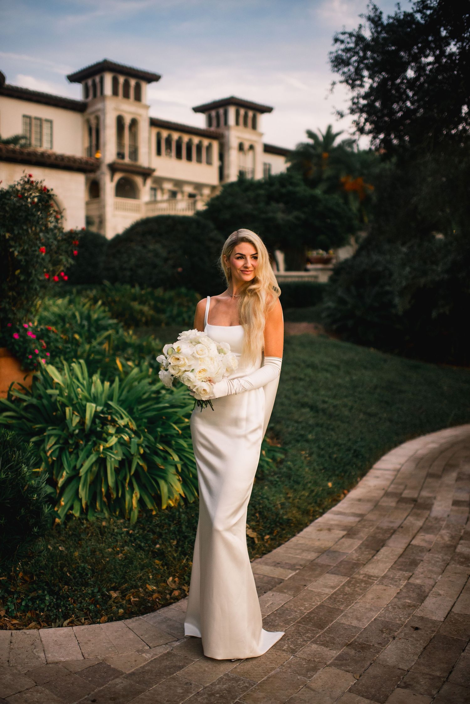 A bridal portrait session at a Mediterranean-style estate with stone pathways and lush gardens at sunset.