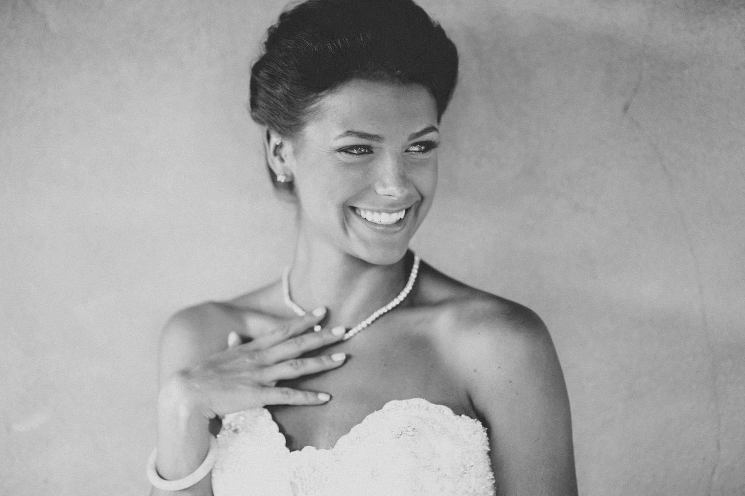 Black and white collage of four candid moments showing joyful expressions and laughter in elegant wedding attire.