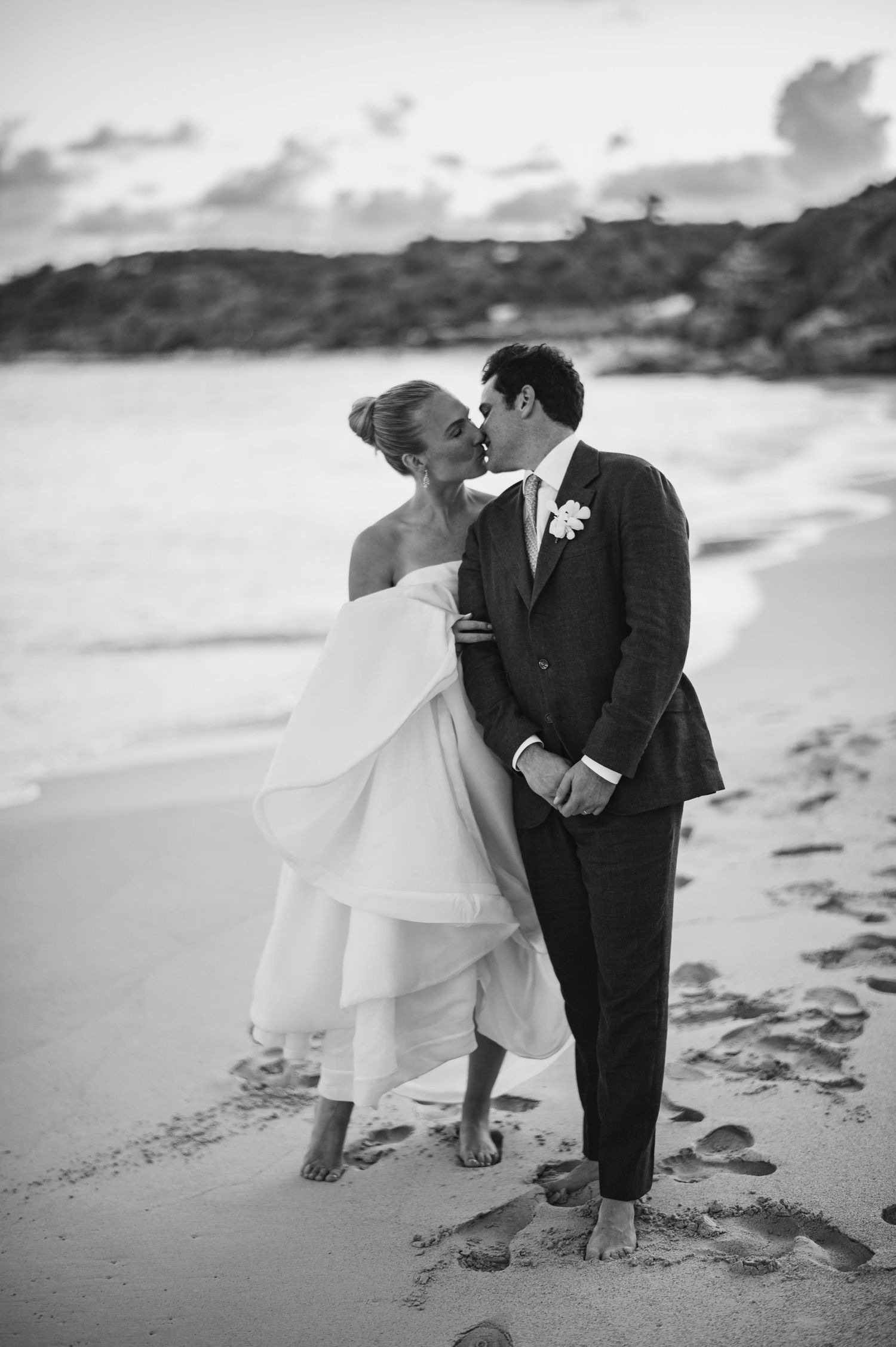 Black and white beach wedding photos capturing romantic moments on the shoreline.