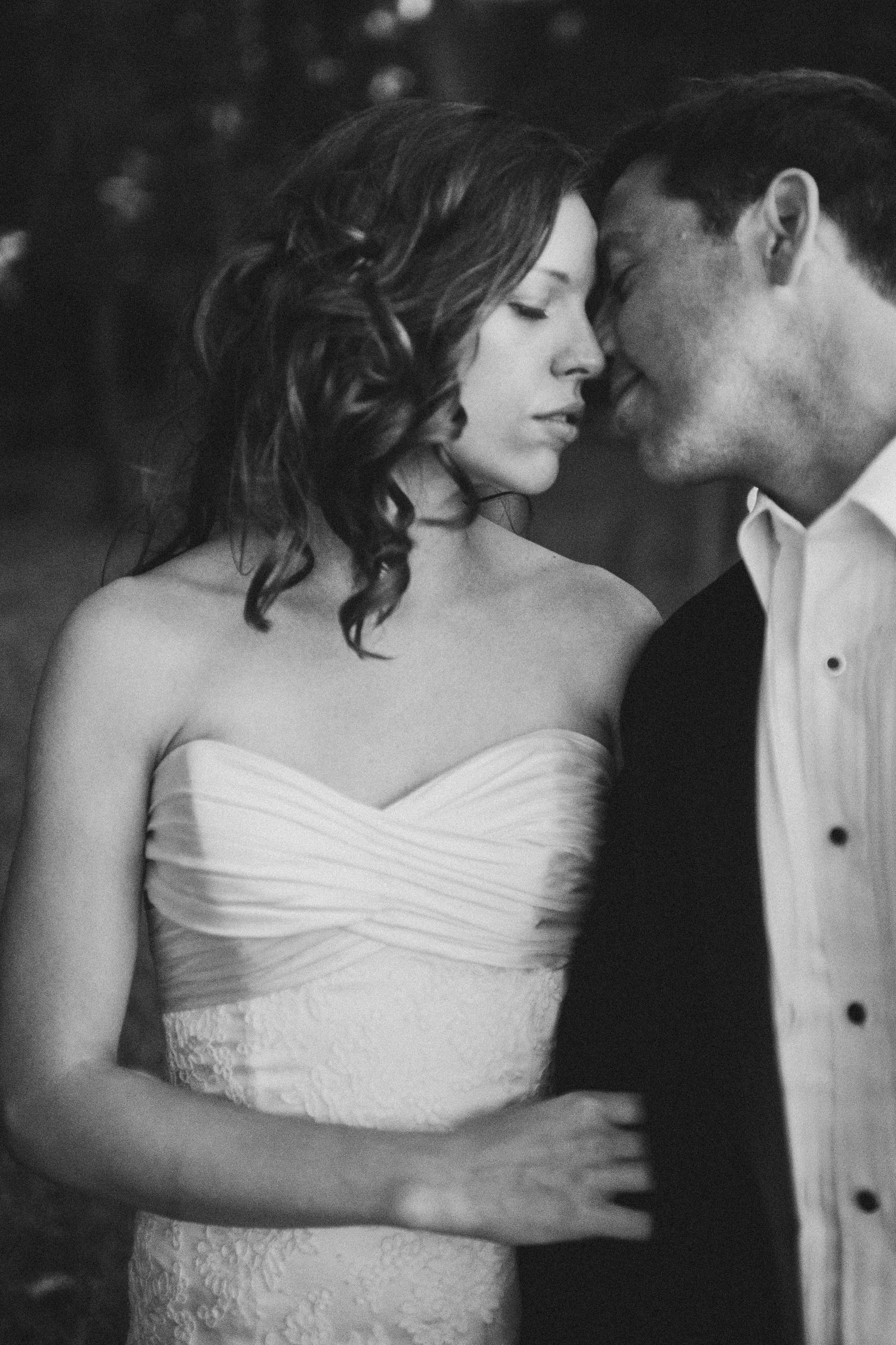 A series of romantic black and white wedding photos showing intimate moments between newlyweds.