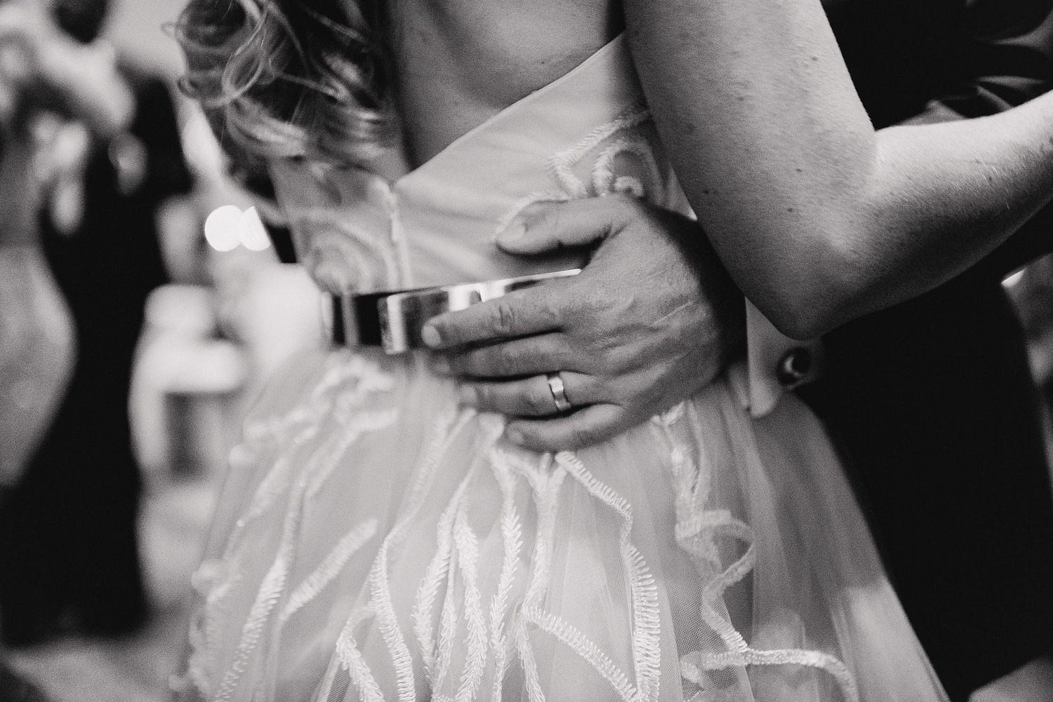 A black and white collage of wedding reception moments showing dancing, champagne toasts and candid celebrations.