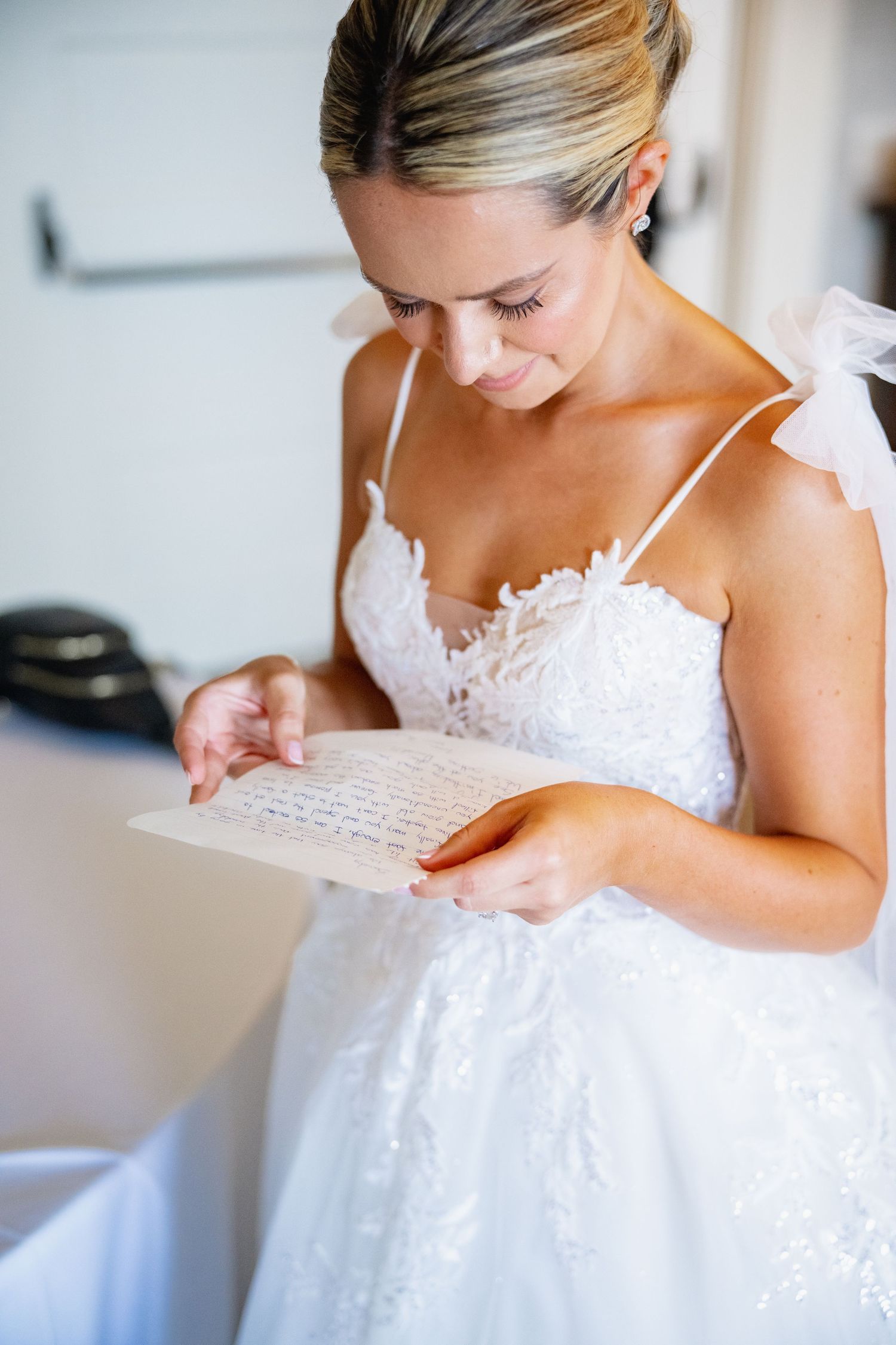 Close-up shots of a white lace wedding dress being prepared before the ceremony.