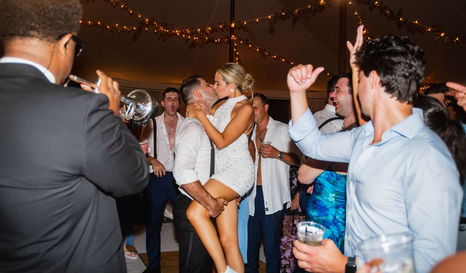 Wedding reception dance party with guests celebrating on the dance floor.