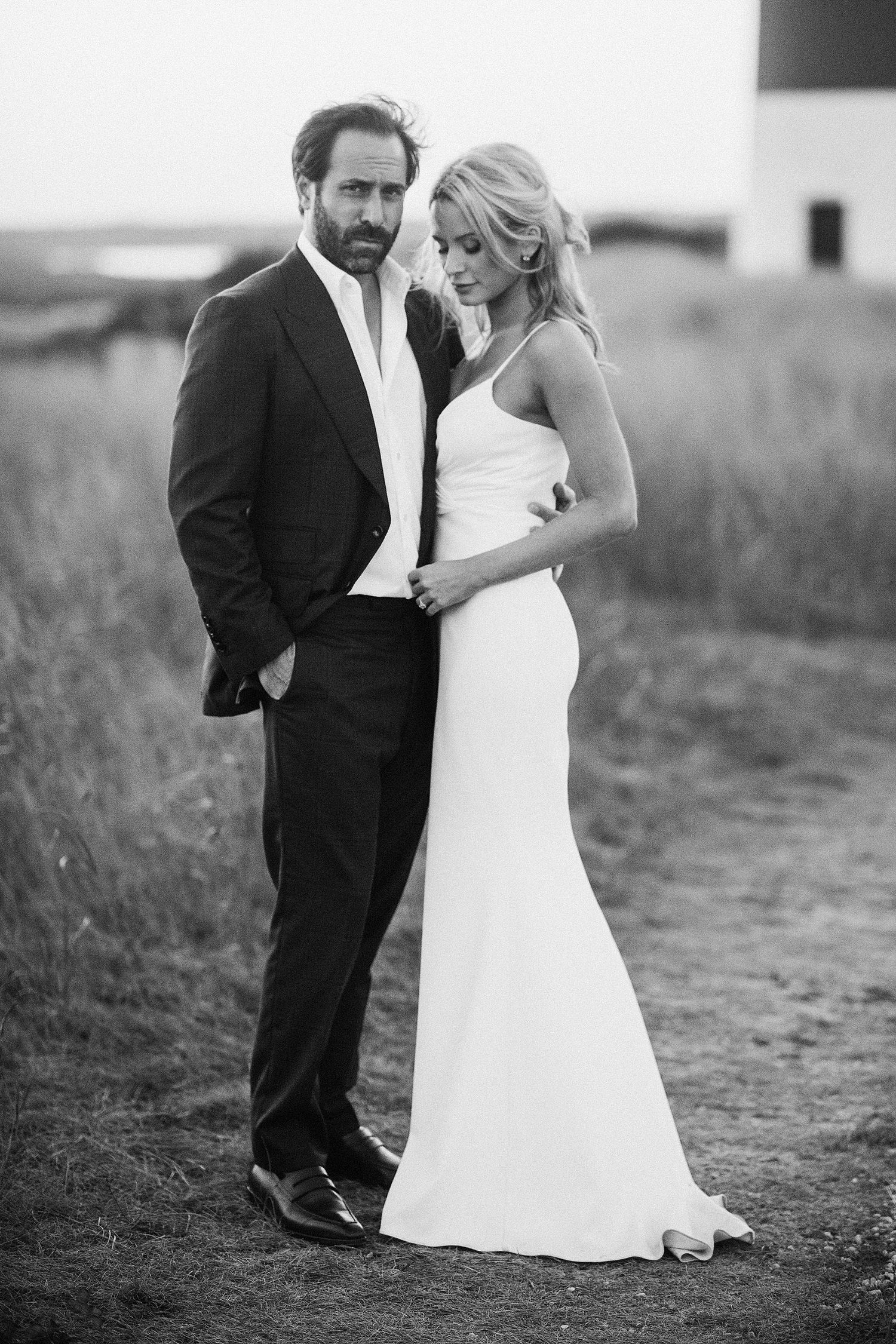 Black and white romantic wedding portraits captured in a rustic outdoor setting.