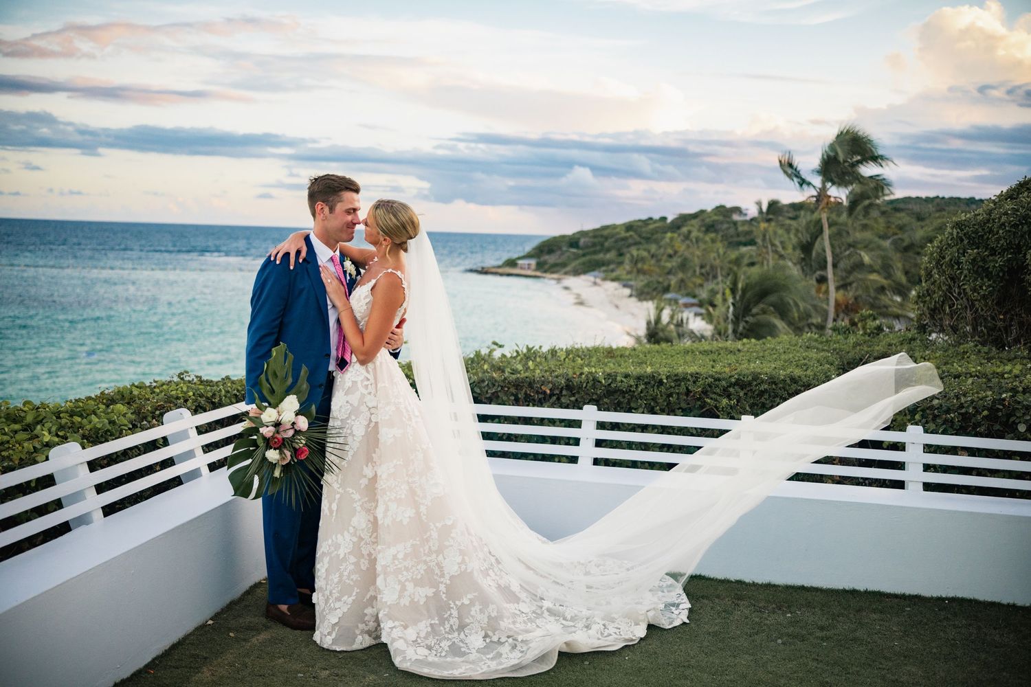 Scenic coastal wedding photos with dramatic sky and ocean backdrop.