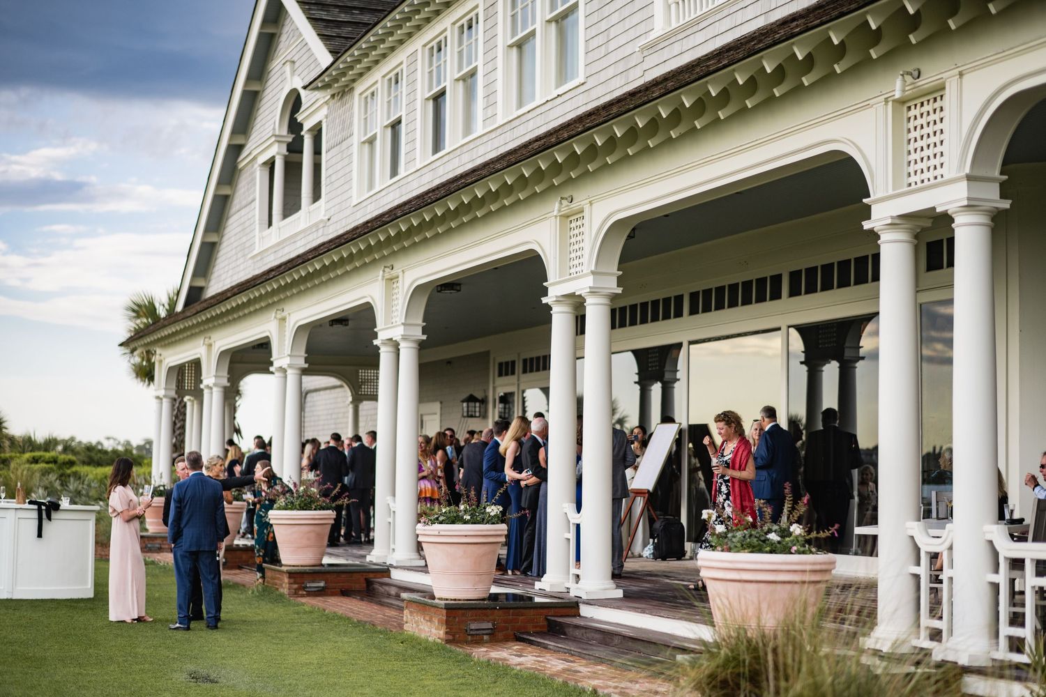A wedding venue with white columns and elegant architecture is shown from multiple angles on a sunny day.