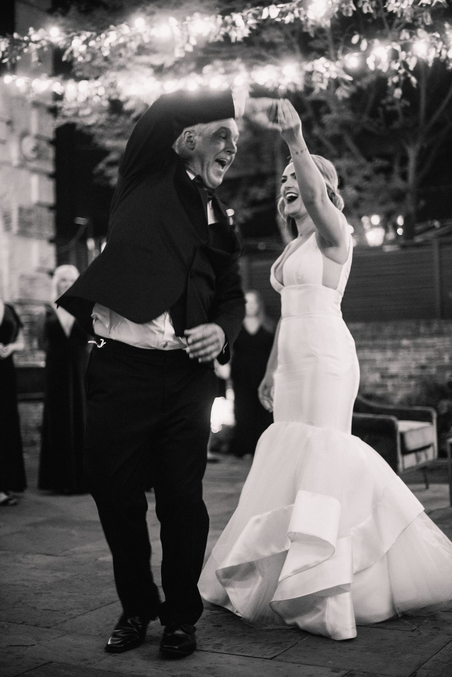 A sequence of black and white wedding photos showing a couple dancing with joyful movement and twirling dress details.