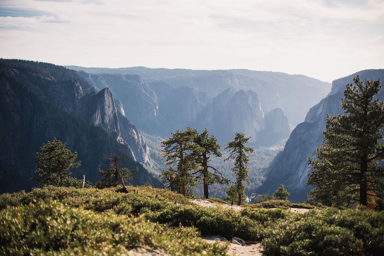 Sweeping vista of Yosemite Valley showing dramatic cliffs and mountain landscape.