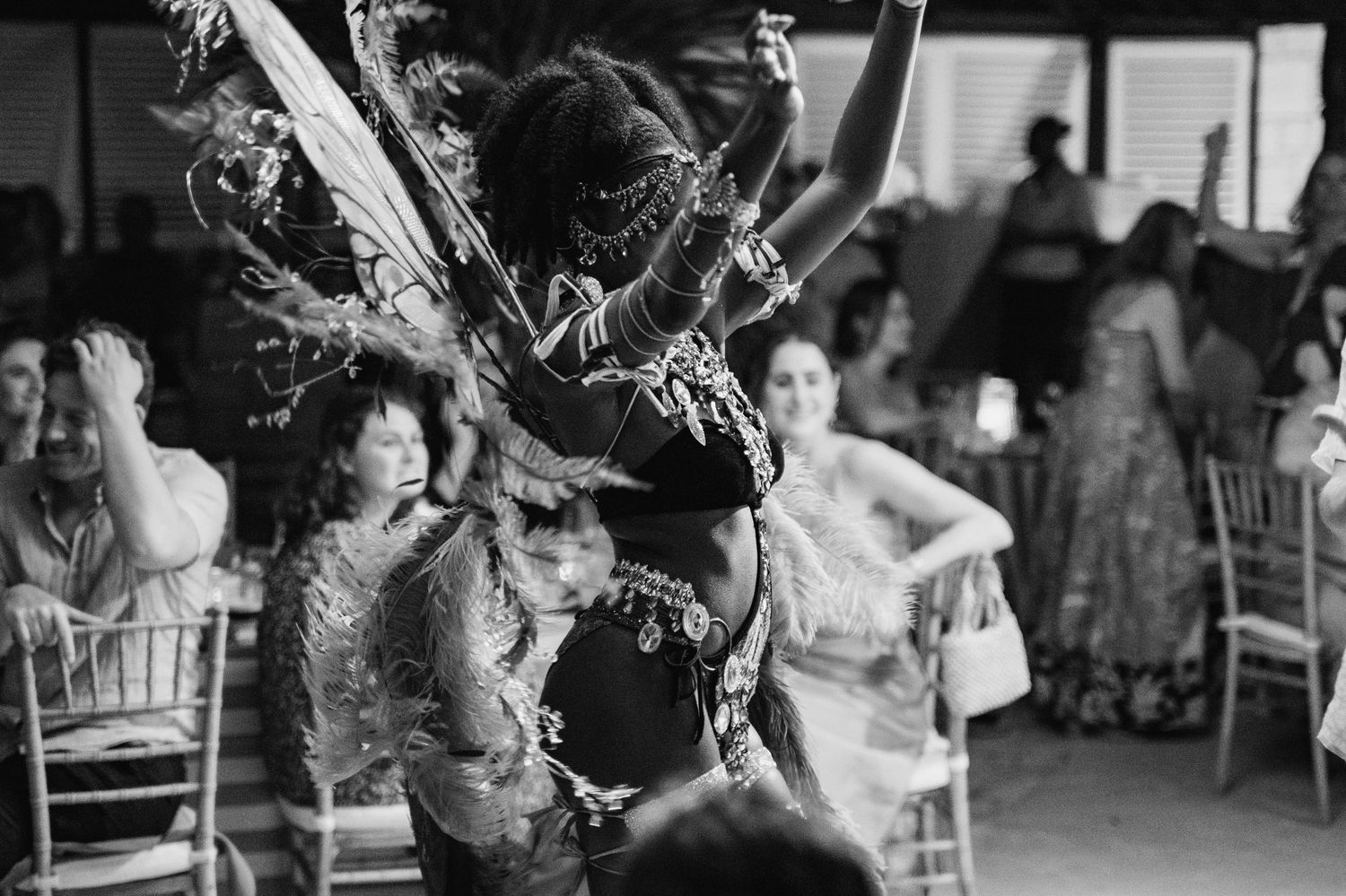 Black and white photo of wedding reception celebration with dancing guests.