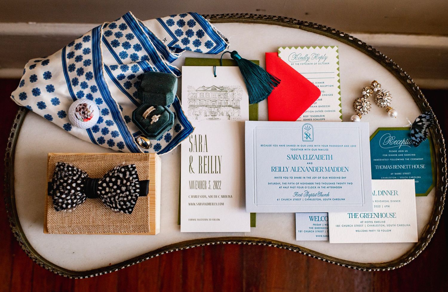 A panoramic view of vintage-style wedding invitations and stationery with blue and white checkered ribbons and decorative elements.