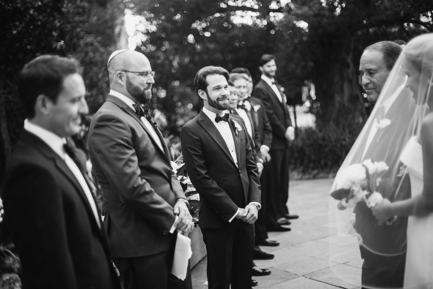 Wedding guests celebrate and share joyful moments during an outdoor reception ceremony.