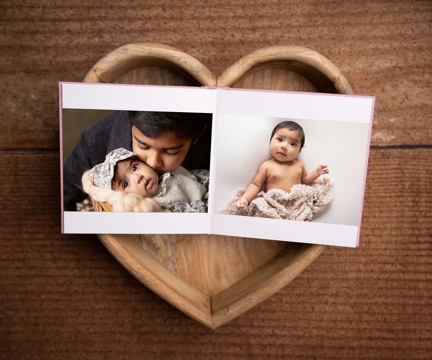 A tender newborn album capturing sweet sibling love alongside a single, peaceful image of baby sleeping soundly.