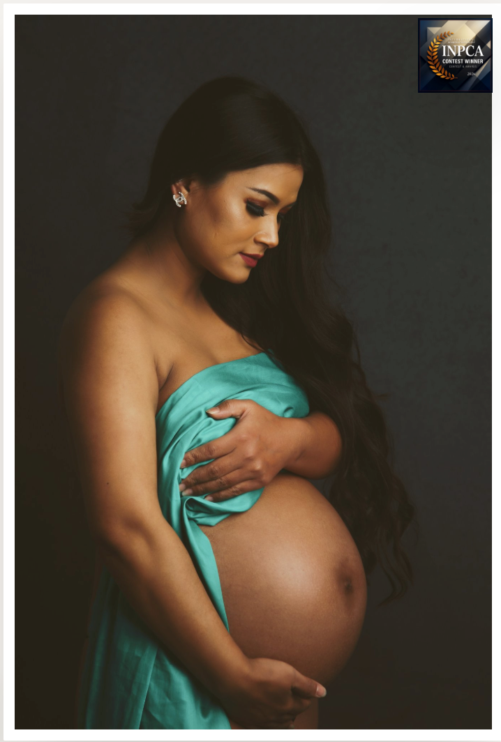 An award winning maternity portrait of mum standing alone with her bump, radiating confidence and beauty.