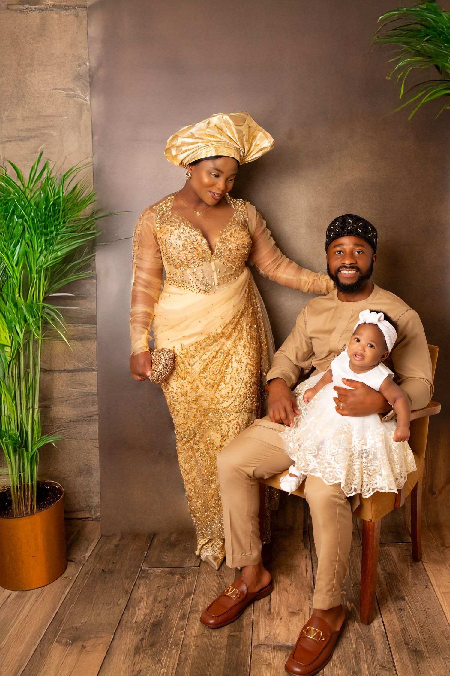 A beautiful family portrait celebrating a seven month old's Nigerian christening alongside proud parents.