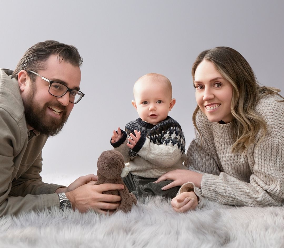 A heartwarming family portrait of mum, dad and their seven month old, capturing love and togetherness.