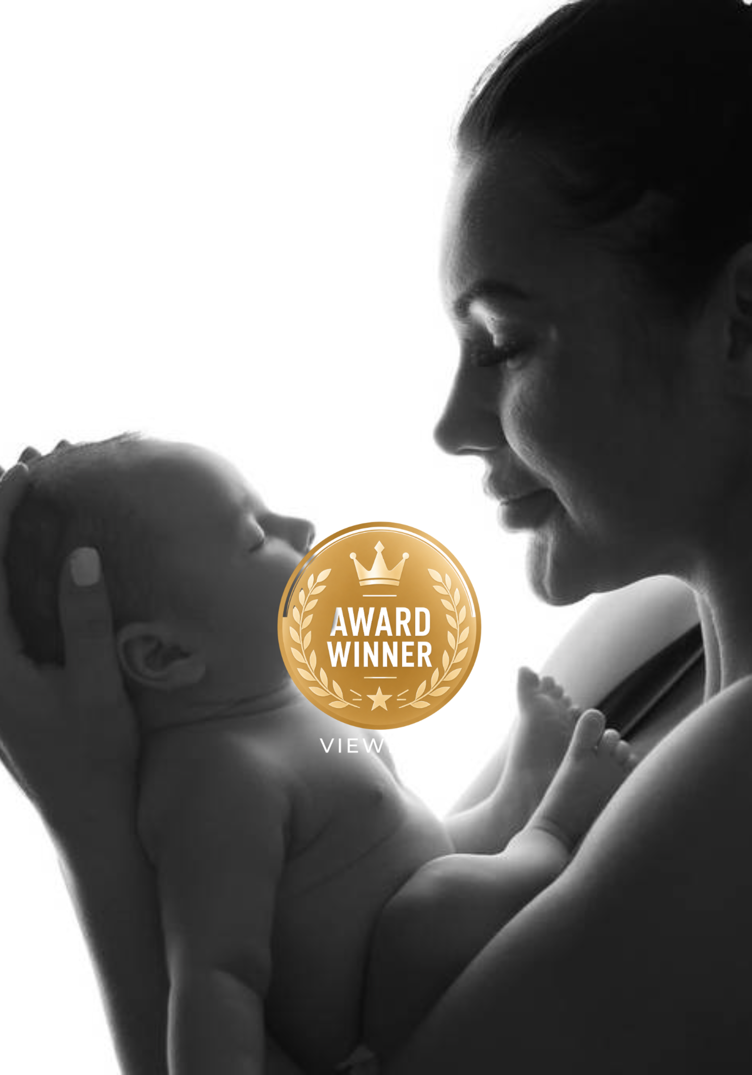 An award-winning black and white silhouette portrait of a mother tenderly holding her newborn baby.