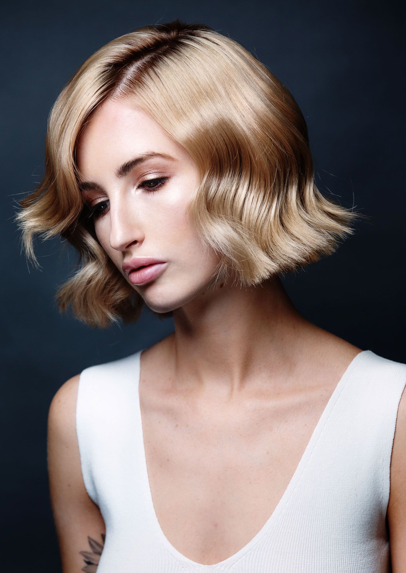 A series of fashion portraits showing a sleek blonde bob hairstyle against a dark background.