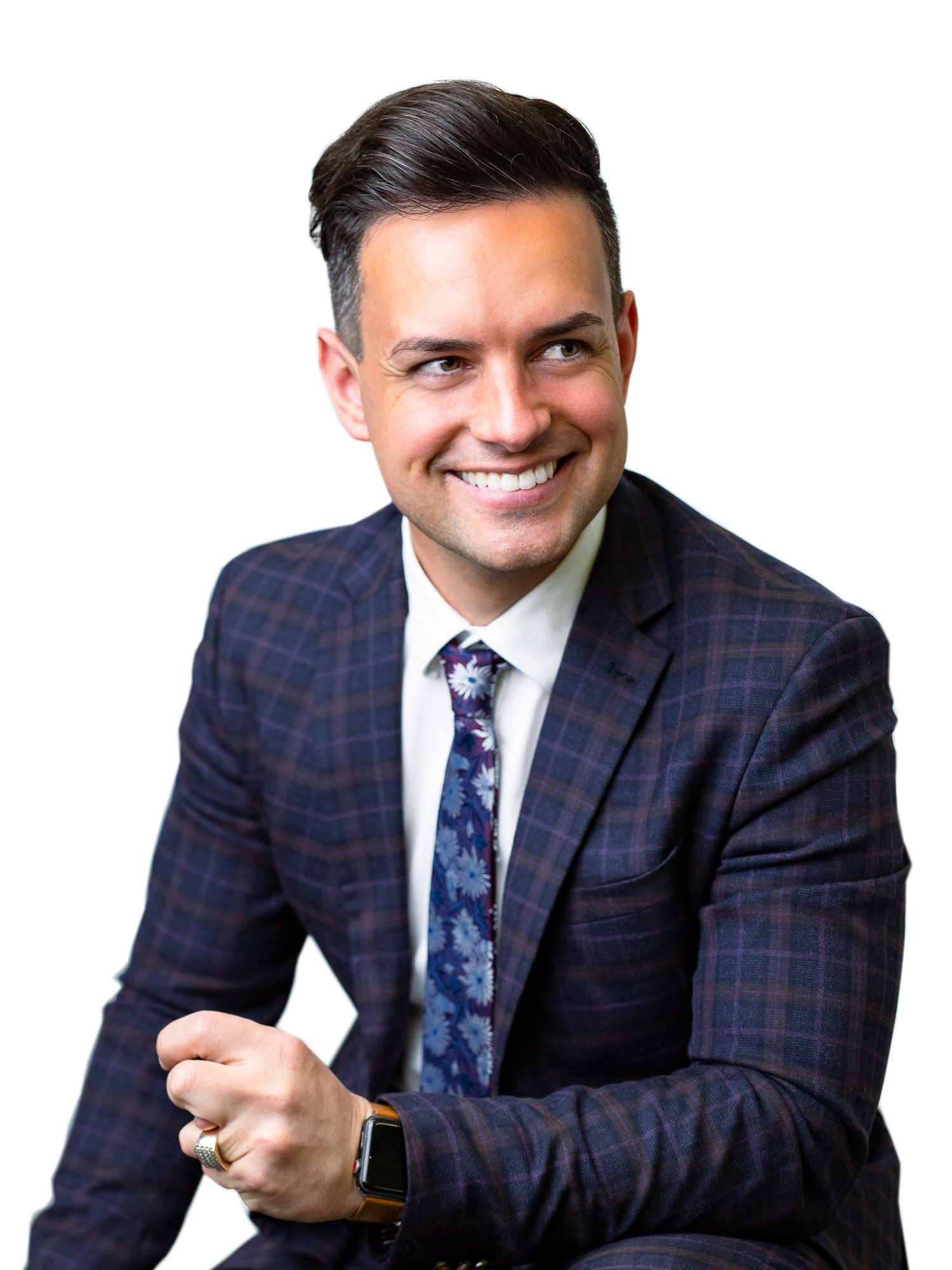 Professional wearing a navy plaid suit and floral tie shows various expressions in a sequence of headshots.