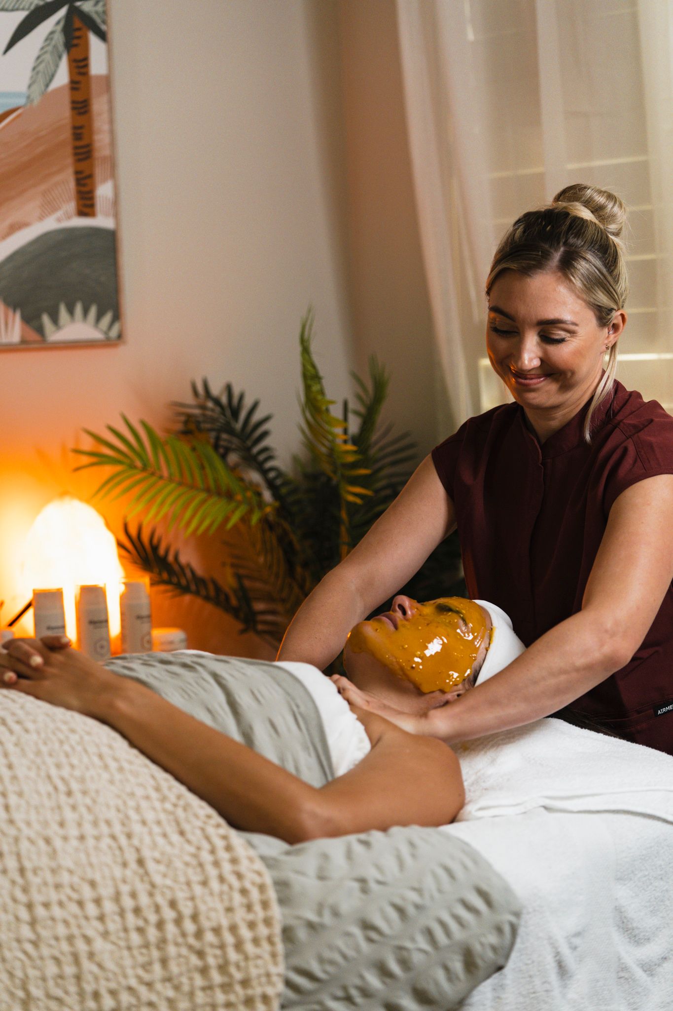 Professional massage therapist performs therapeutic massage techniques on client during relaxing spa treatment session.