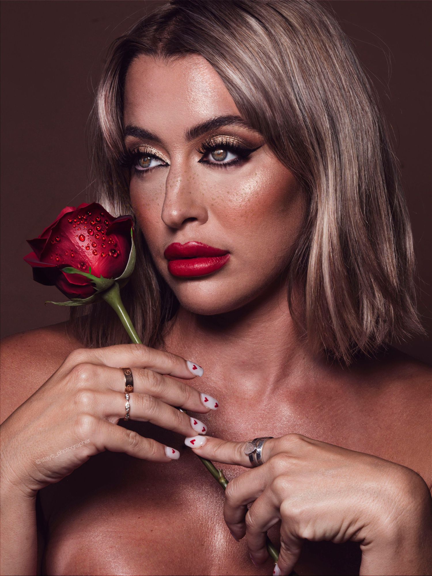 Romantic beauty portraits with red rose, bold lips and dramatic lighting.