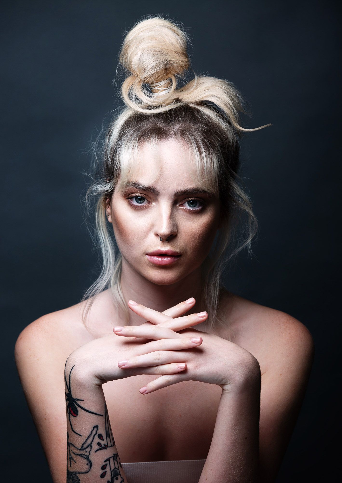 A series of artistic portraits showing a person with blonde hair against a dark background in different poses.