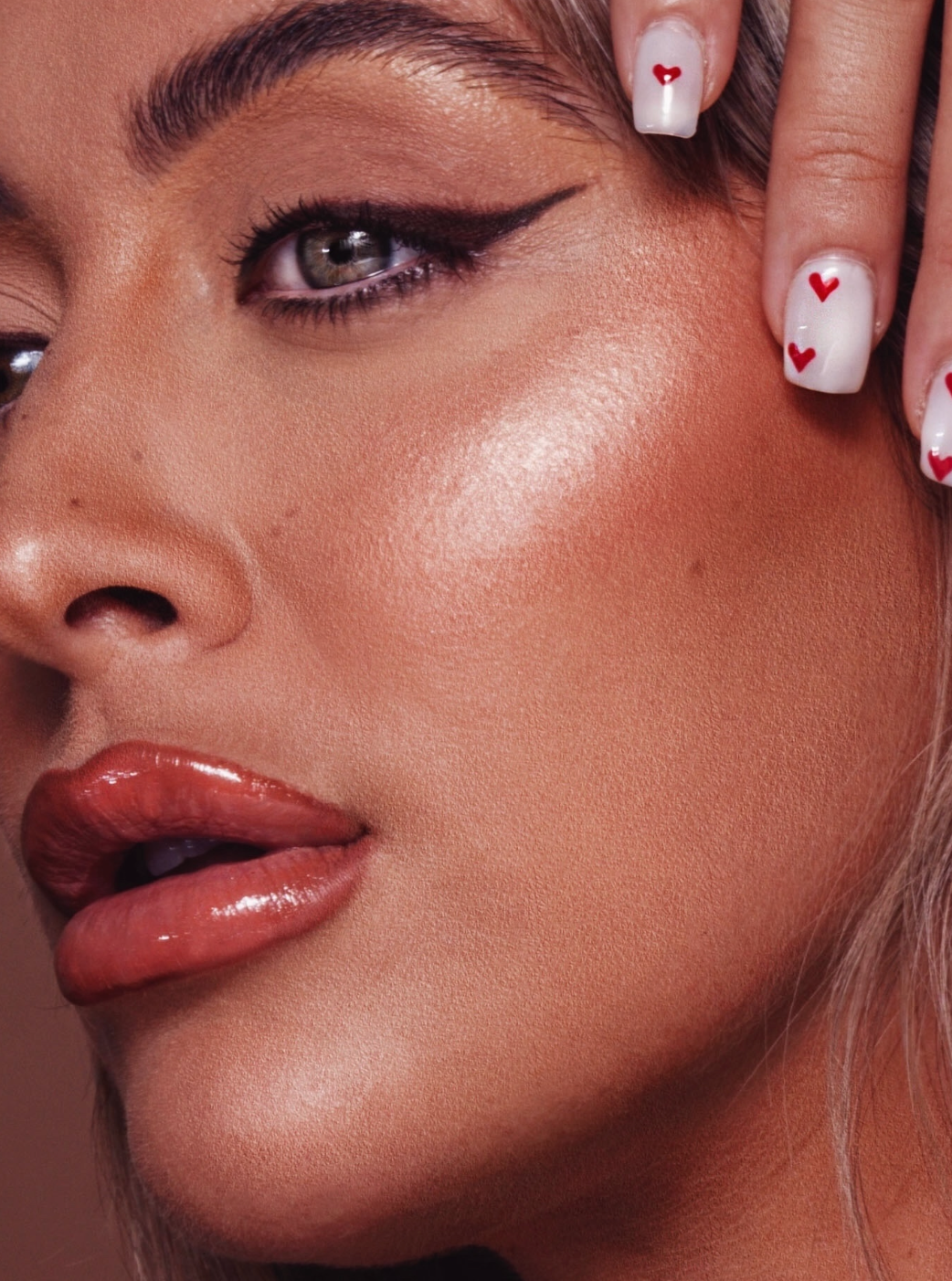 Artistic beauty shots featuring winged eyeliner and glossy nude lips with manicured nails.