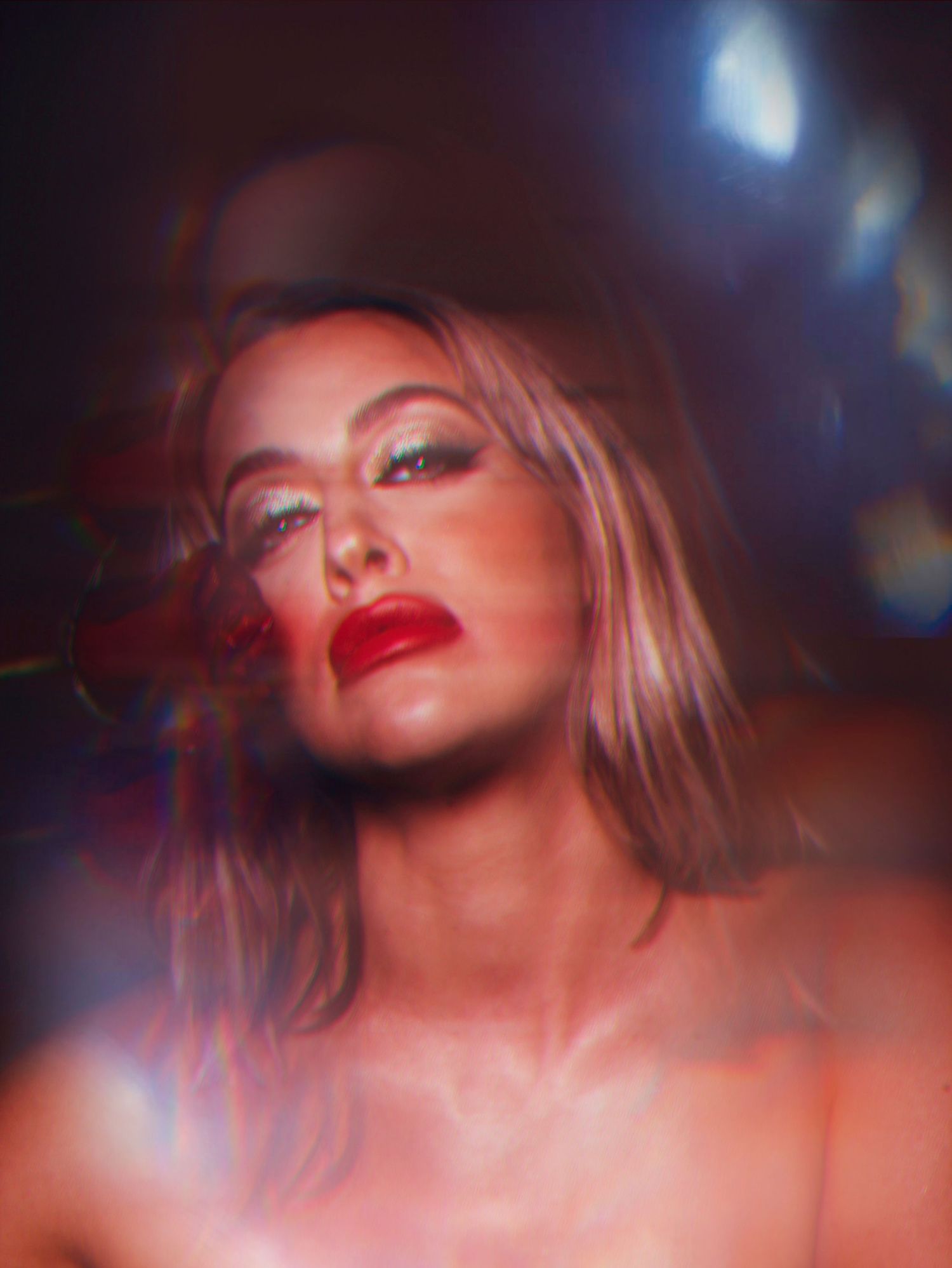 Artistic beauty portrait with dramatic lighting and red tones.