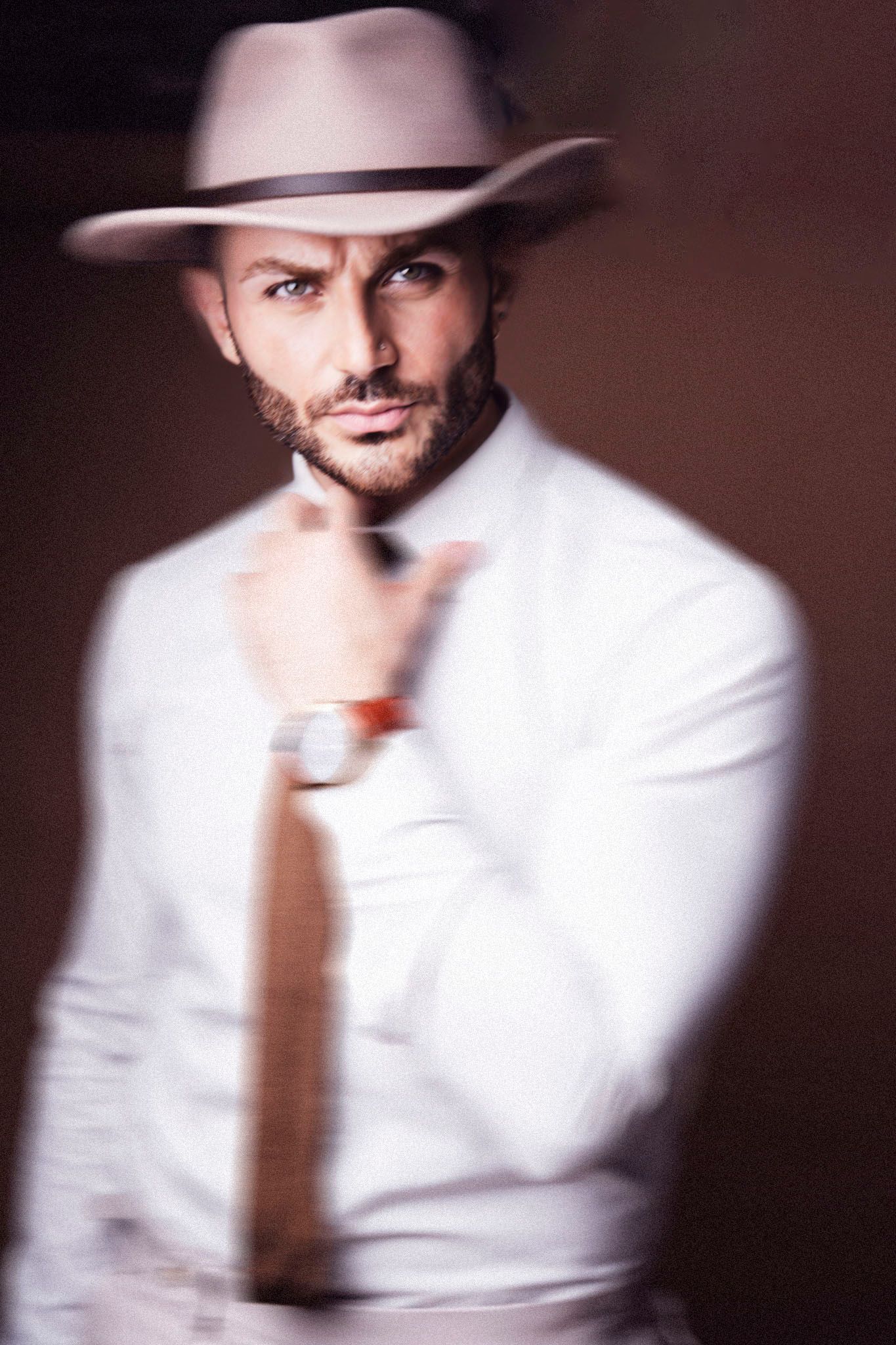 Motion blur portrait series featuring white shirt and brown tie.