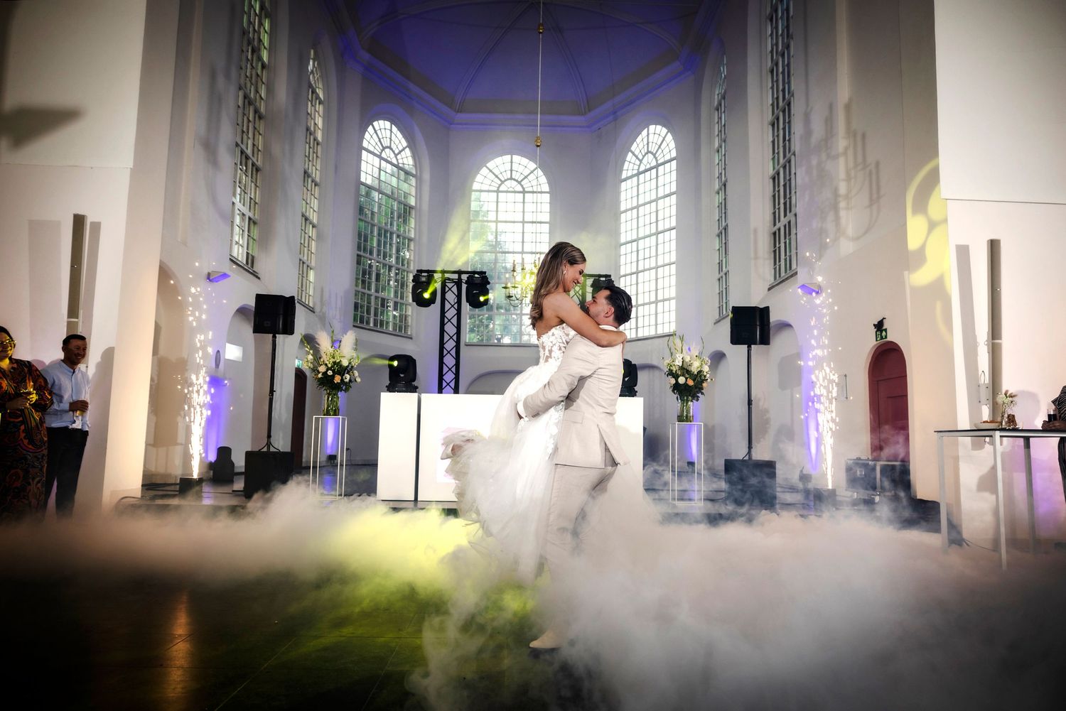 A dramatic misty scene inside a church with two figures in flowing white dresses creating ethereal movements against stained glass.