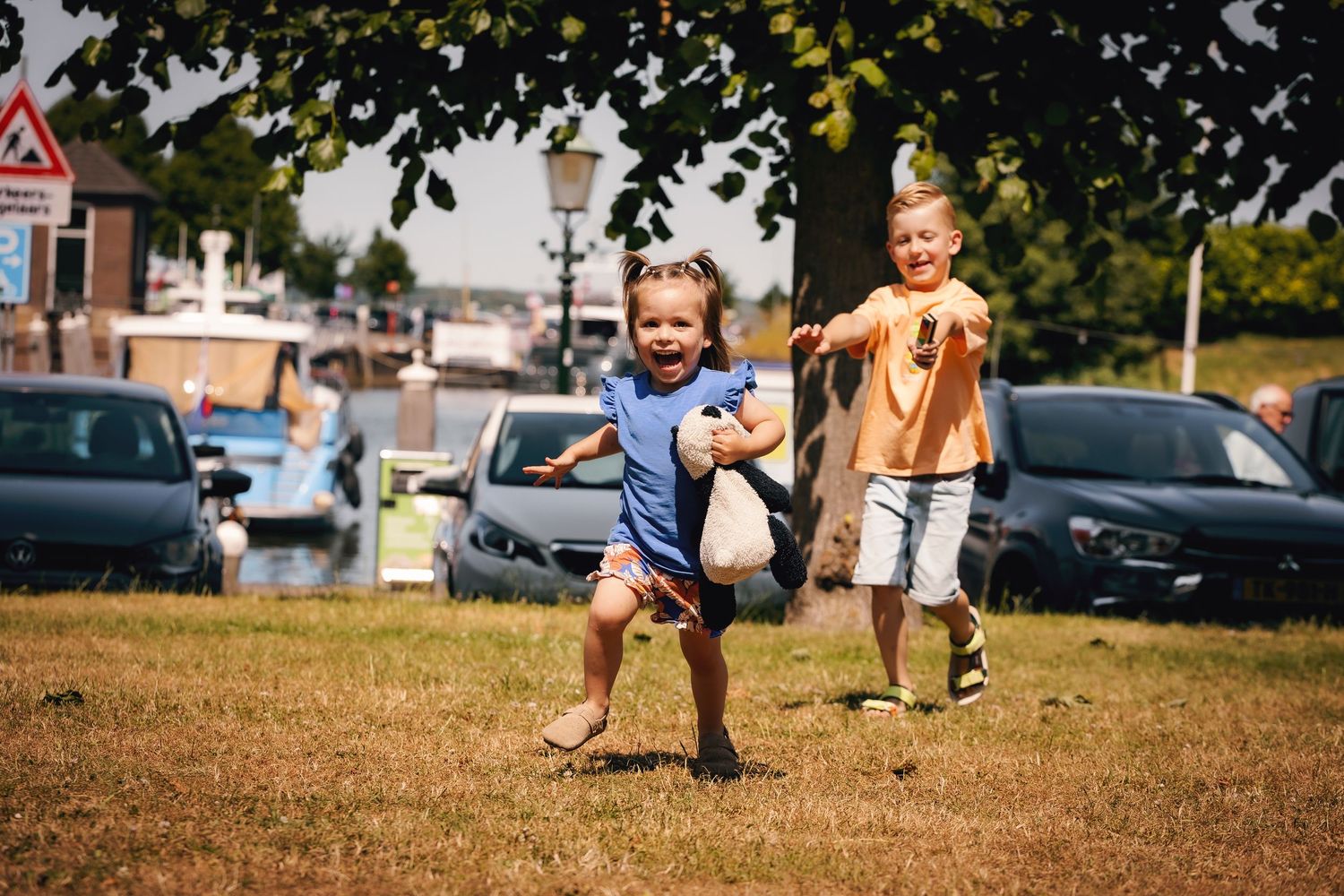 Four images of children playing and running across a sunny grass field during outdoor activities.