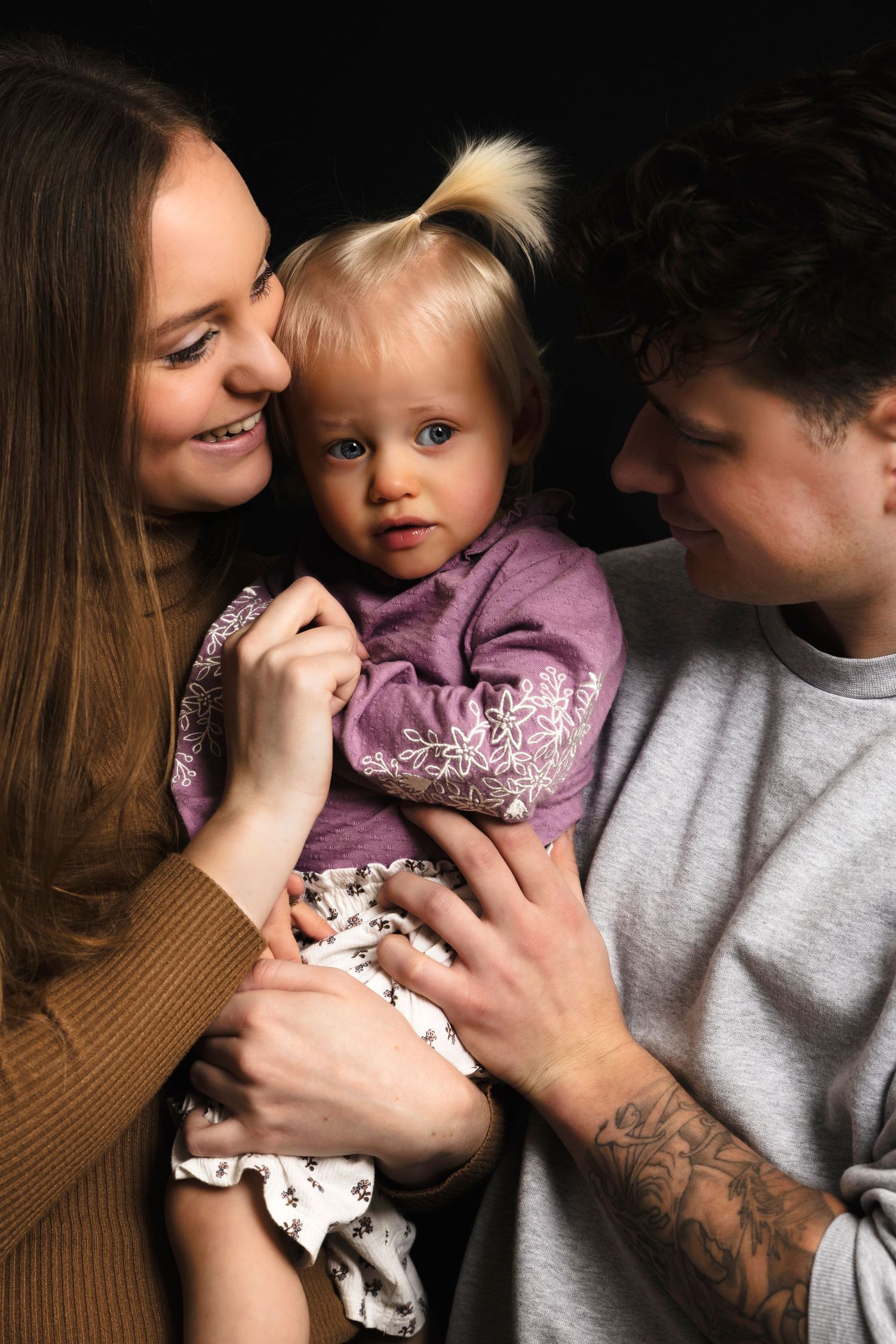 A sequence of intimate family moments showing affection and closeness between parents and child in matching tones.