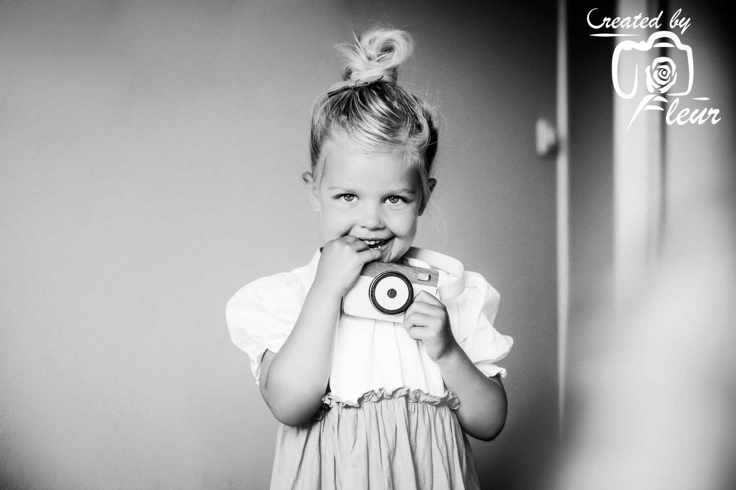 A sequence of 3 vintage black and white photographs showing a child's expressions and reactions with a camera.