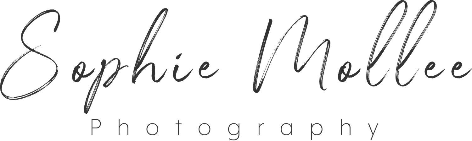 A black and white handwritten signature appears on a light background.