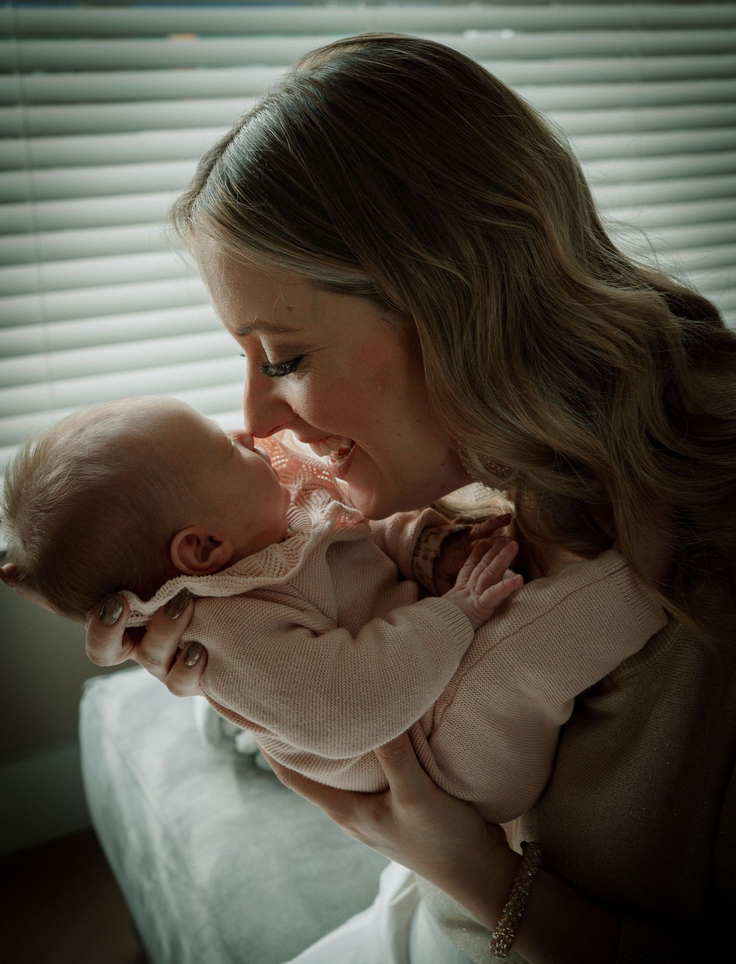 A tender moment between parent and baby captured in a series of intimate black and white photographs.