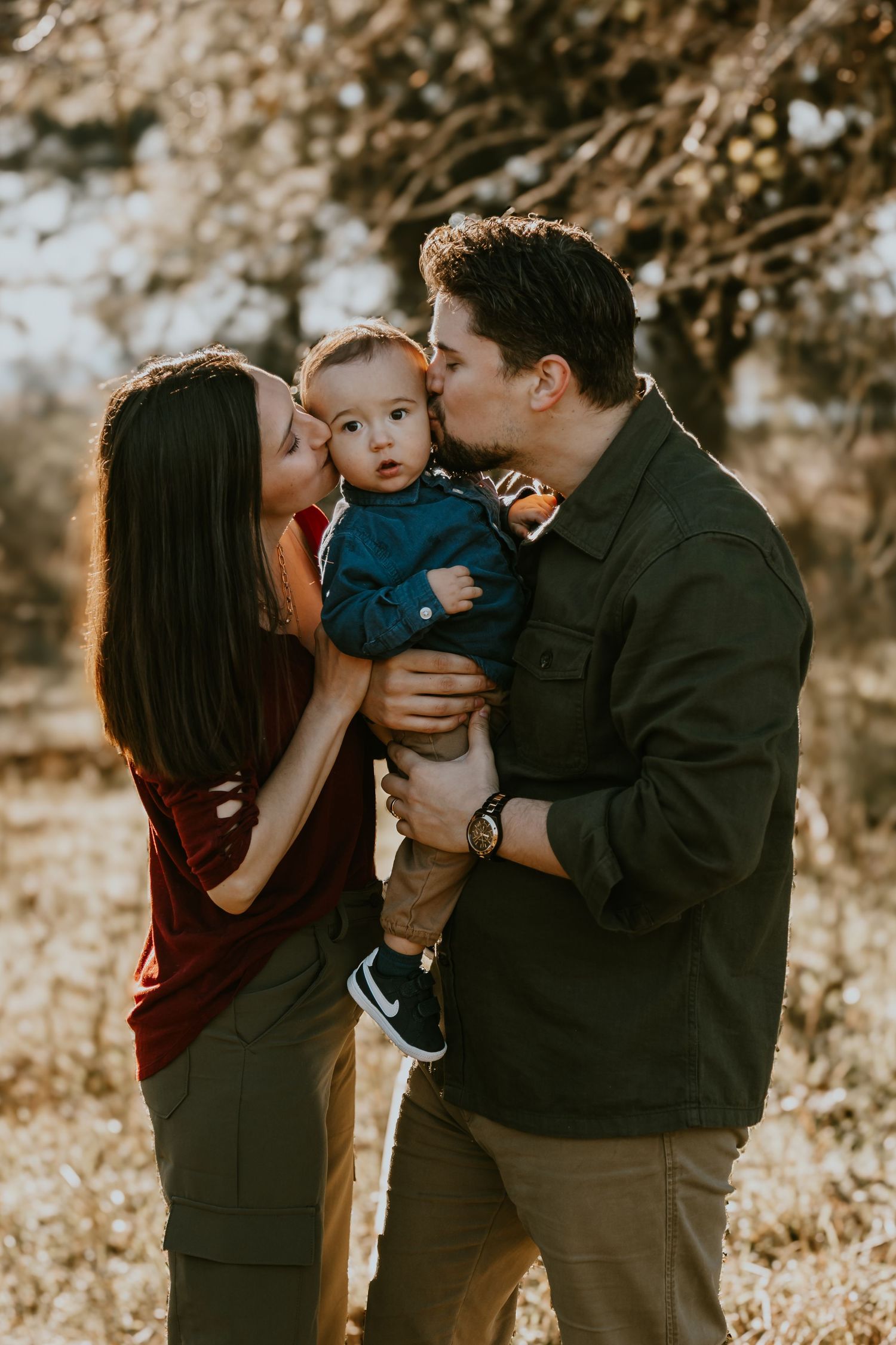 A loving family shares tender moments together during a golden sunset photoshoot in nature.