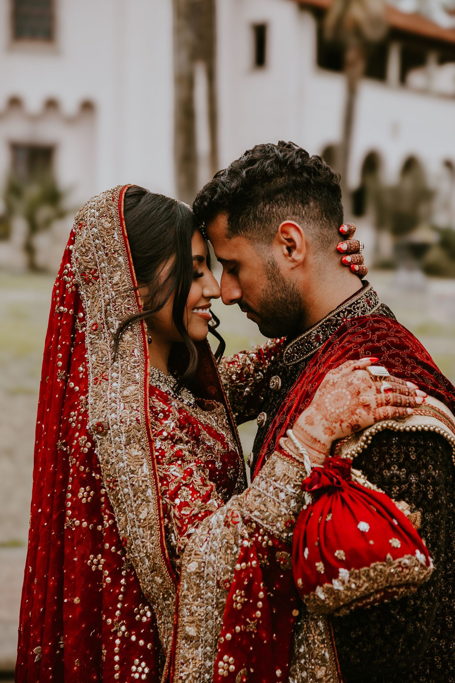 A couple wedding attire share an intimate moment.
