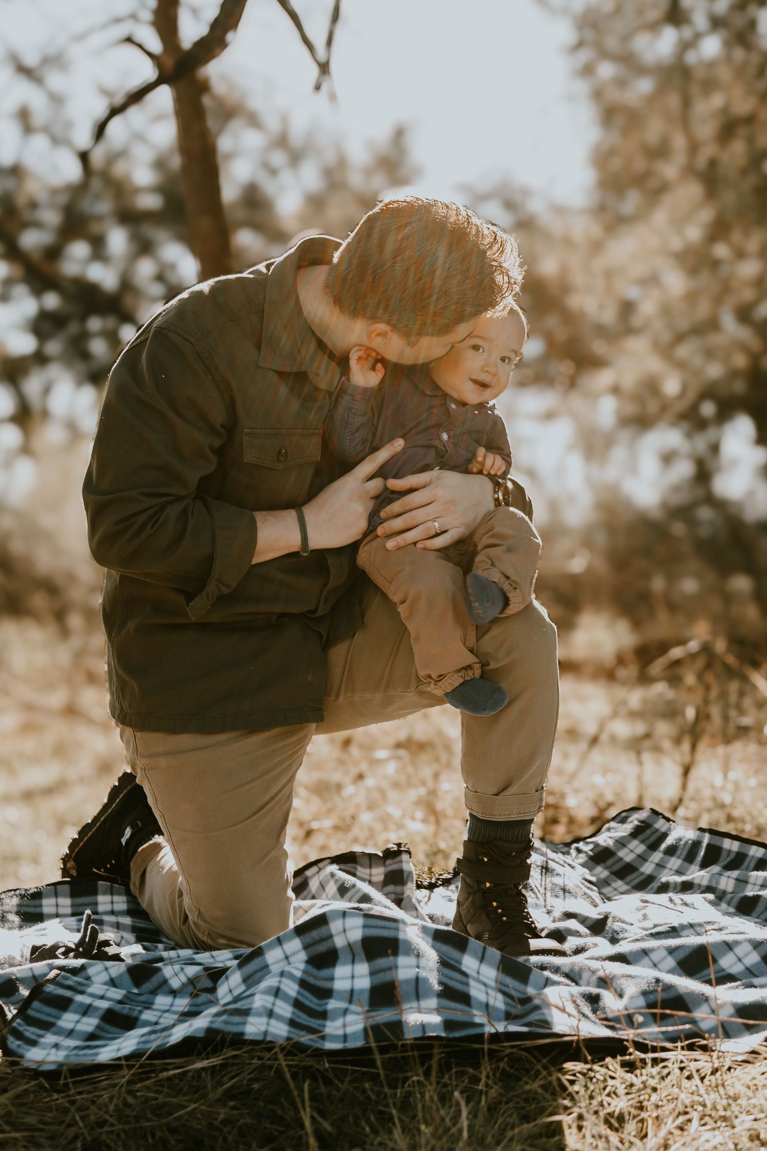 Intimate outdoor scene with plaid blanket picnic on a sunny autumn day in sepia tones.