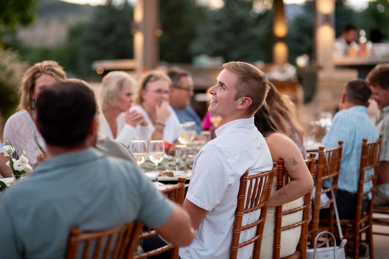 Young man at an event laughing, at Lazy Stud Ranch in Lyons, CO.