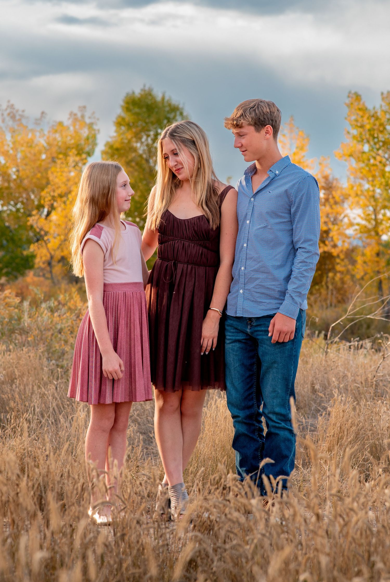 three siblings looking at each other