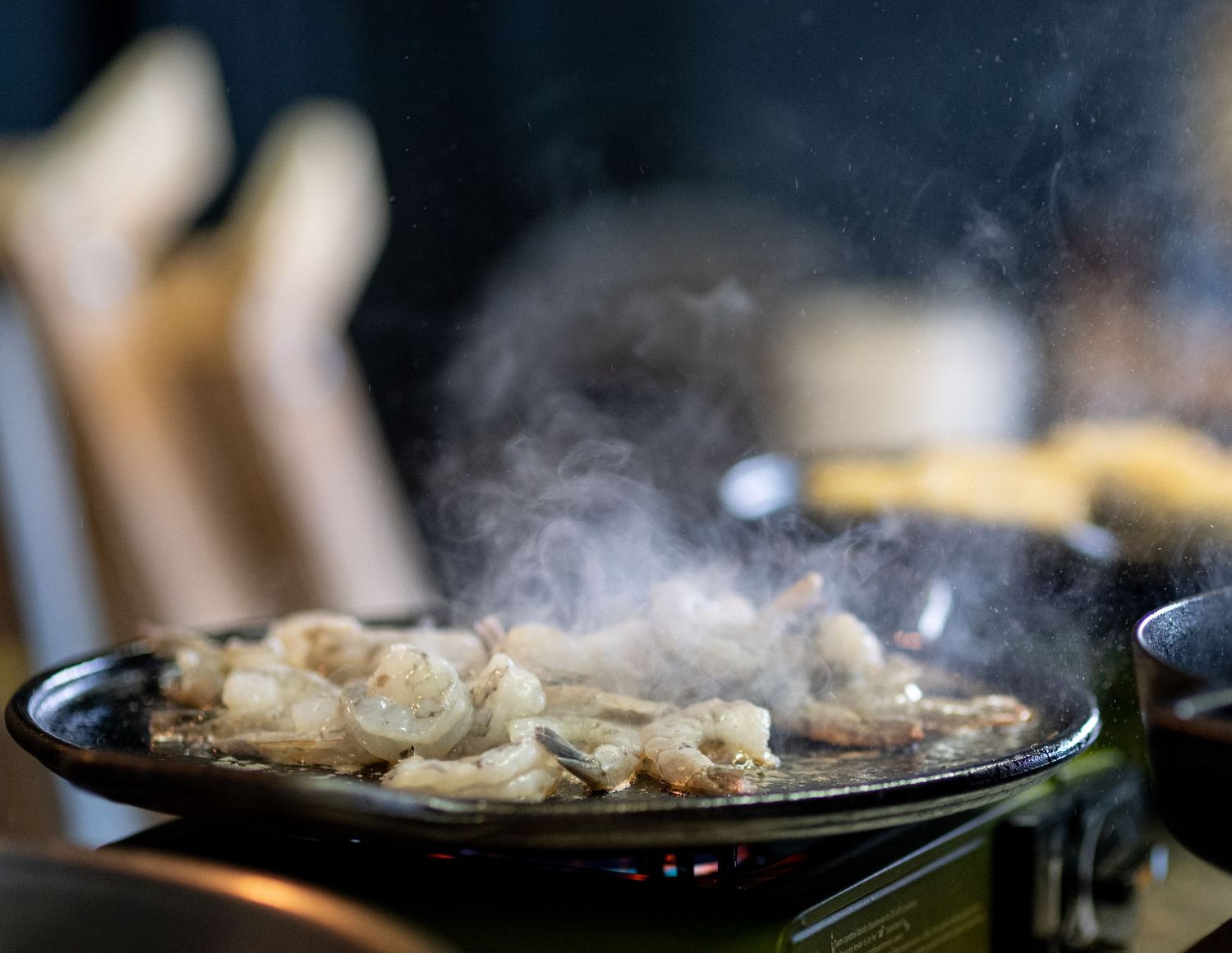 shrimp being cooked with smoke rising off of it