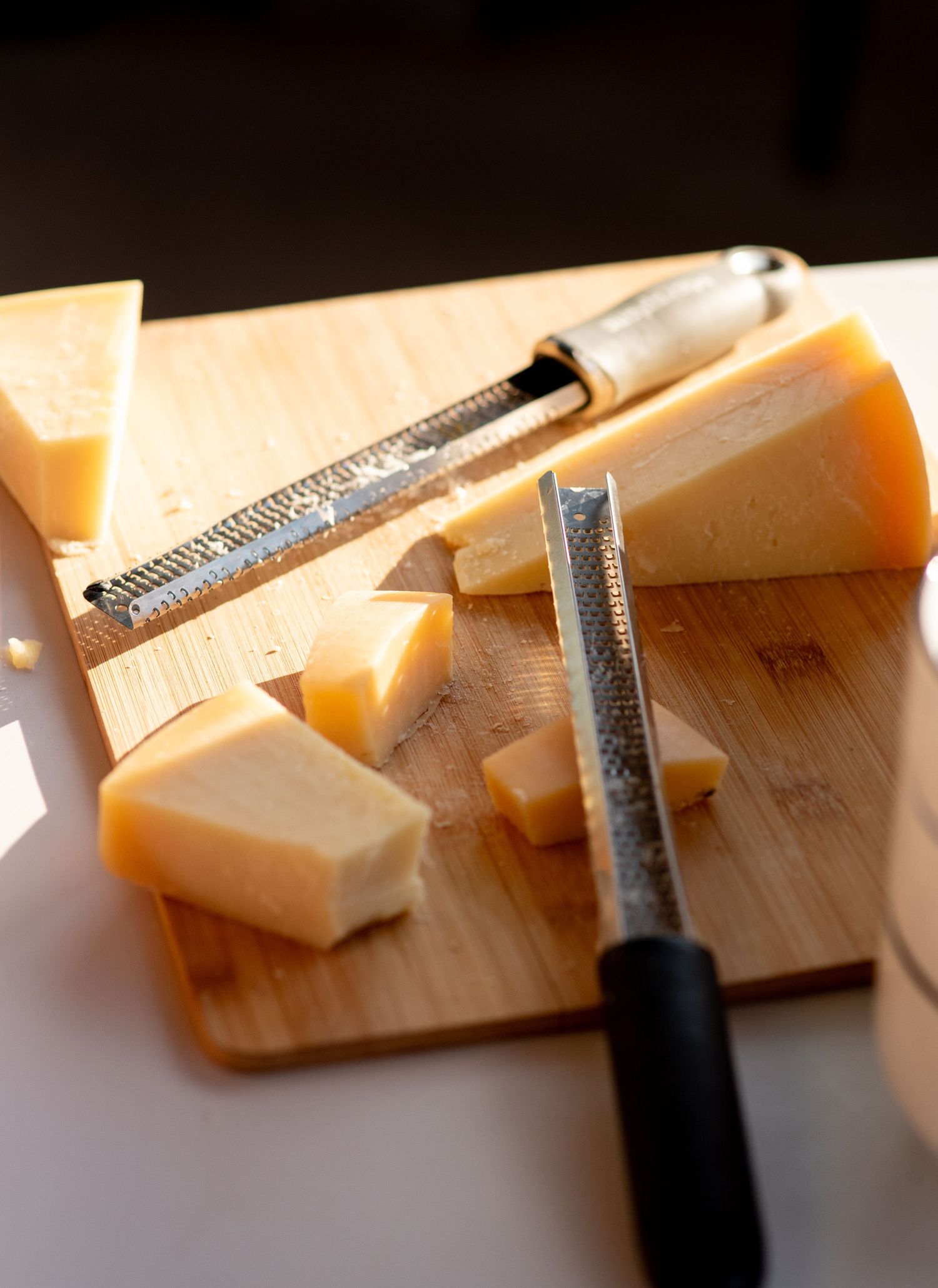 Parmesean cheese half sliced. Photo by Elijah Grace Photo.