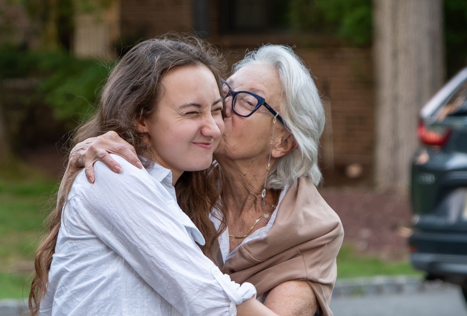Woman kissing a young ladies cheek. Photo by Elijah Grace Photo.